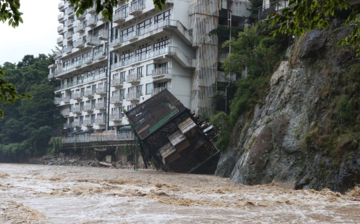 A hotel building falls into the floodwaters at Nikko mountain resort in Tochigi prefecture, north of Tokyo on 10 September 2015. Authorities in central Japan ordered tens of thousands to flee their homes after torrential rains flooded rivers and triggered landslides. Picture: AFP.