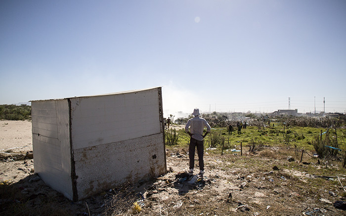 A man stands next to his newly completed shack in what settlers named 'Azania', the area of land they invaded next to the Nolungile Station in Khayelitsha. Picture: Thomas Holder/EWN