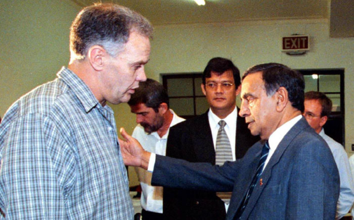 FILE: Former Transport Minister Dullah Omar (R) makes a concilliatory gesture to convicted killer and former apartheid assassin Ferdi Barnard (left) during a break at a hearing of the Truth and Reconciliation Commission (TRC) in Cape Town 02 October 2000. Ferdi Barnard applied for amnesty for the attempted murder of Omar. Picture: AFP