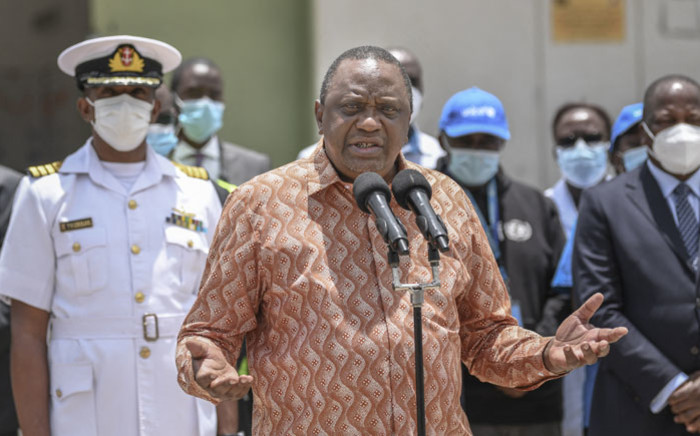 Kenya's President Uhuru Kenyatta (C) gives an address following his tour of the Nairobi National Vaccine Depot where the country's first batch of COVID-19 vaccines are preserved in cold storage in Nairobi on 4 March 2021. Picture: AFP