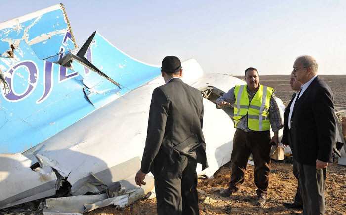 A handout picture released by Egypt's Prime Minister's office on 31 October 2015, shows PM Sherif Ismail (R) at the site of the wreckage of a crashed A321 Russian airliner in Hassana a mountainous area of Egypt's Sinai Peninsula. Picture: AFP