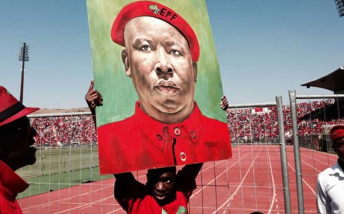 A supporter holds up a painting of EFF leader Julius Malema at a pre-election rally in Atteridgeville, Pretoria. Picture: Sebabatso Mosamo/EWN. 