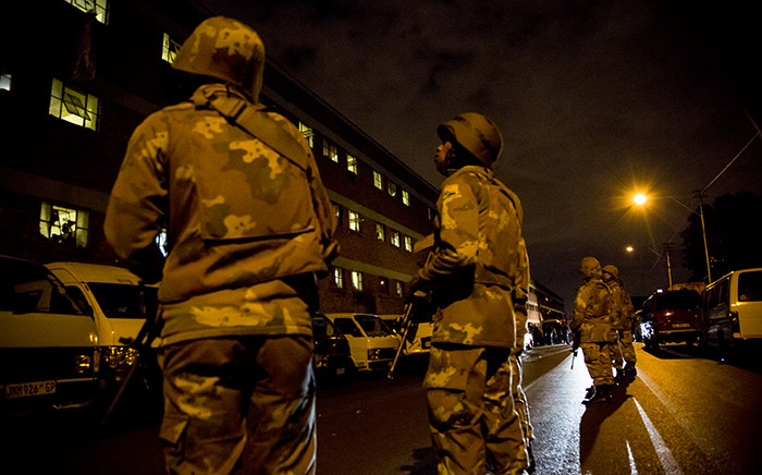 FILE. Police and members from SANDF launched a massive raid at the Jeppestown hostel, searching for illegal weapons, drugs and stolen goods on 21 April 2015. Picture: Thomas Holder/EWN.