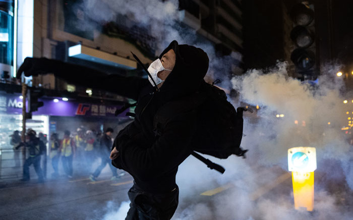 A protester reacts after police fire tear gas to disperse bystanders in a protest in Jordan district in Hong Kong, on early 25 December 2019. Picture: AFP
