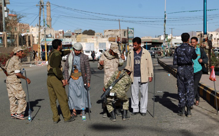FILE: Members of Shiite Huthi movement check people as they arrive for a gathering in a northern Sanaa stadium to watch on a giant screen a televised address by their chief Abdel Malek al-Huthi on 7 February, 2015.