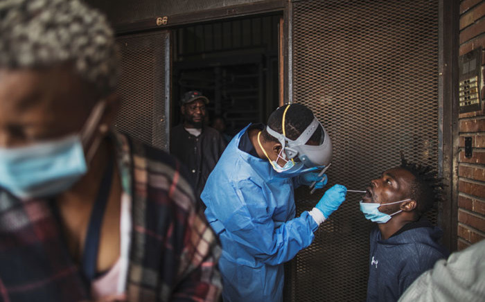 FILE: A Gauteng Health Department official collects samples from a man during a door-to-door COVID-19 coronavirus testing drive in Yeoville, Johannesburg, on 3 April 2020. Picture: AFP