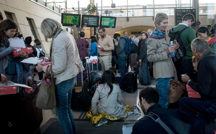 Stranded passengers wait at the Calais-Frethun train station in northern France to cross to the United Kingdom in the early hours of September 2, 2015. Hundreds of passengers were left stranded in dark, stifling Eurostar trains in the early hours after several suspected migrants climbed onto the tracks near the French port of Calais. Picture: AFP