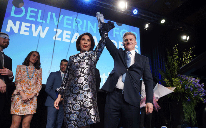 Leader of the National Party Bill English (R) and his wife Mary (L) react onstage at the party's election event at SkyCity Convention Centre in Auckland on 23 September 2017. New Zealanders went to the polls on 23 September to elect a new parliament. Picture: AFP.