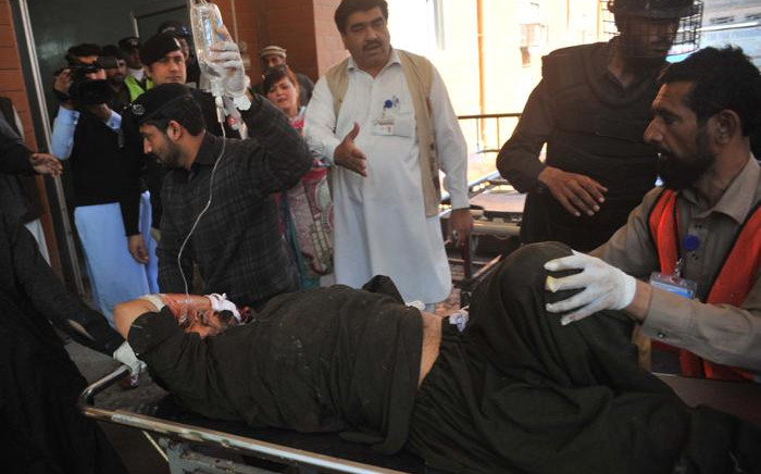 Pakistani volunteers move a blast victim to a hospital in Peshawar on 21 February, 2017, after multiple Taliban suicide bombings at a court complex in the Tangi area of Charsadda district. Picture: AFP.