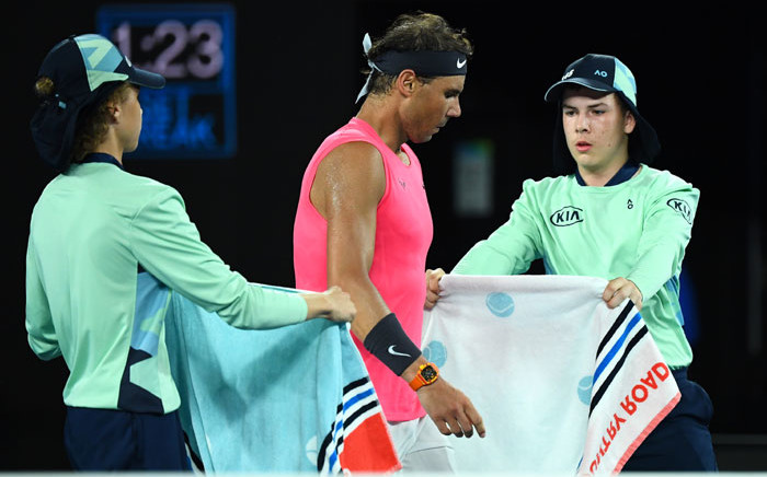 FILE: Ball boys give towels to Spain's Rafael Nadal during a break in his men's singles quarterfinal match against Austria's Dominic Thiem on day ten of the Australian Open tennis tournament in Melbourne on 29 January 2020. Picture: AFP.