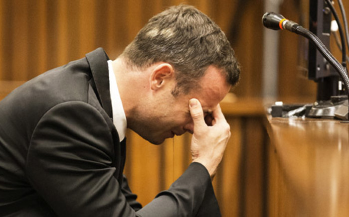 Oscar Pistorius while a witness recounts to the court the moments after the murder during the fourth day of his trial at the High Court in Pretoria on 6 March 2014. Picture: Pool.