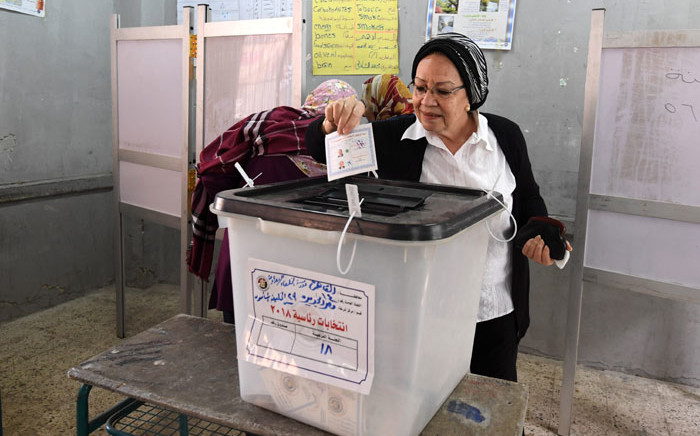 An Egyptian voter casts her vote in a polling station in the capital Cairo's eastern neighbourhood of Heliopolis on the first day of the 2018 presidential elections on 26 March, 2018. Picture: AFP