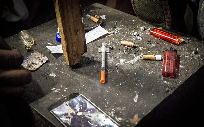 A table inside a heroin den holds spent lighters, a used needle, old cigarette ends and piece of foil used for chasing the drug in Woodstock, Cape Town. Picture: Thomas Holder/EWN