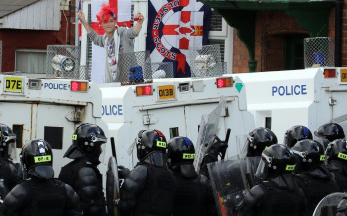 Loyalist supporters confront police at Woodvale Road, after their parade was banned from marching past the Nationalist Ardoyne shops in north Belfast, Northern Ireland on 13 July 2015. Picture: AFP.