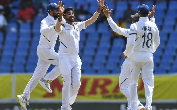 Hanuma Vihari (L) and Jasprit Bumrah (2L) of India celebrate the dismissal of Kraigg Brathwaite of West Indies during day 4 of the 1st Test between West Indies and India at Vivian Richards Cricket Stadium in North Sound, Antigua and Barbuda, on 25 August 2019. Picture: AFP
