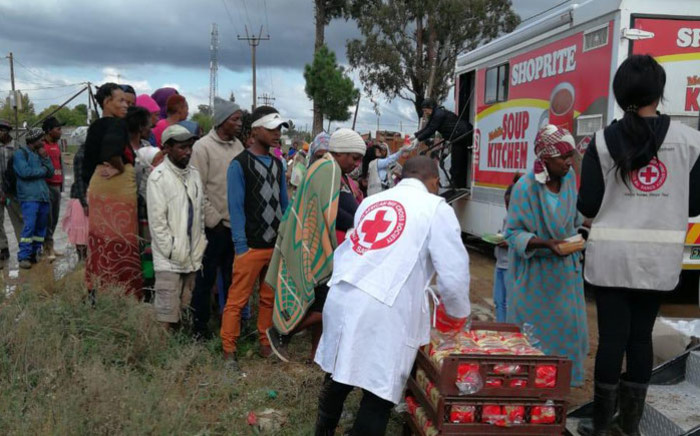Victims of the recent floods in KwaZulu-Natal receive meals from the Red Cross. Picture: @SARedCross/Twitter