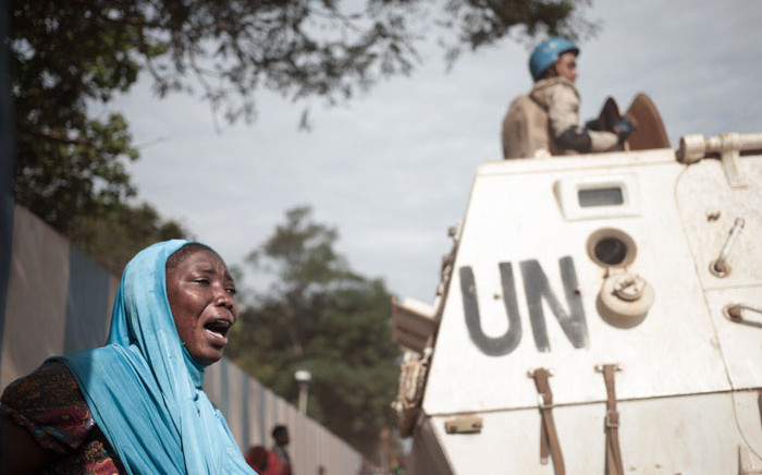 FILE: A woman reacts next to UN soldiers as inhabitants of the mainly Muslim PK5 neighbourhood demonstrate in front of the headquarters of MINUSCA, the UN peacekeeping mission in the Central Africa Republic, in Bangui. Picture: AFP