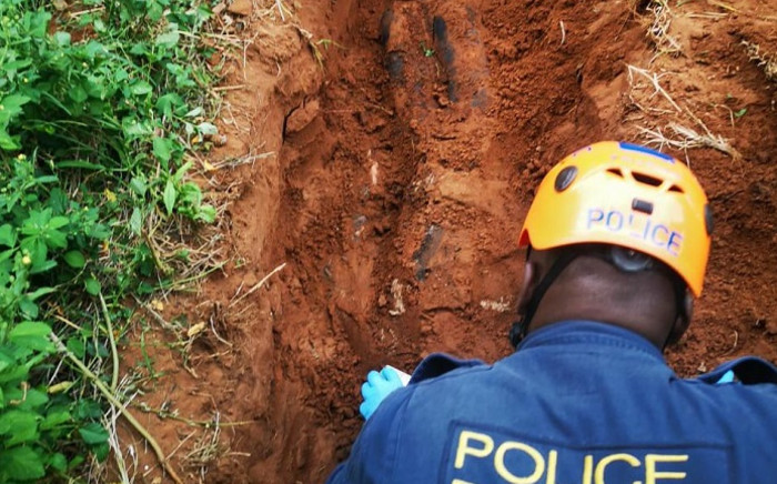 Police dig in a shallow grave after a 19-year-old man from Wentworth in Durban, KwaZulu-Natal confessed to killing and burying the body of a 39-year-old woman on 11 March 2021. Picture: SAPS.
