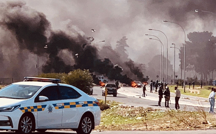 FILE: In this file photo, law enforcement officers are pictured on scene where Kraaifontein residents barricaded roads after their homes were demolished on 26 July 2020. Picture: Supplied.