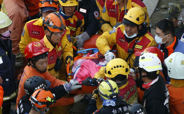 A female survivor said to be from Vietnam is carried away after being rescued from a collapsed building following the early 06 February 6.4 magnitude earthquake, in Tainan City, southern Taiwan, 08 February 2016. More than 100 people are still missing two days after a 6.4-magnitude earthquake killed at least 37 in southern Taiwan, while three people were rescued alive, authorities said. Picture:EPA/RITCHIE B. TONGO