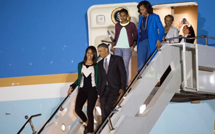 US President Barack Obama and First Lady Michelle Obama walk off Air Force One with their daughters Malia and Sasha at Waterkloof Air Force Base on June 28, 2013.  Picture: AFP
