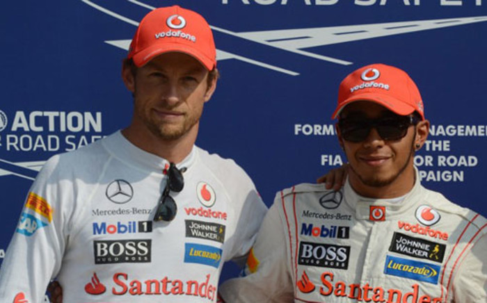 FILE: McLaren Mercedes' British driver Jenson Button (L) and McLaren Mercedes' British driver Lewis Hamilton pose in the parc ferme at the Autodromo Nazionale circuit in Monza, Italy, on September 8, 2012. Picture: AFP.
