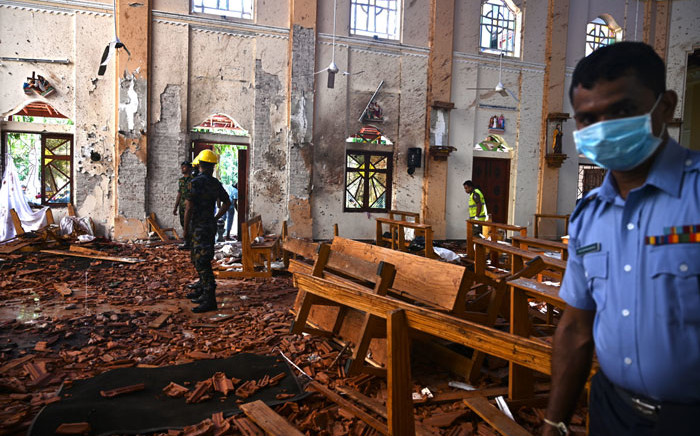 FILE: Security personnel inspect the interior of St Sebastian's Church in Negombo on 22 April 2019, a day after the church was hit in series of bomb blasts targeting churches and luxury hotels in Sri Lanka. Picture: AFP.
