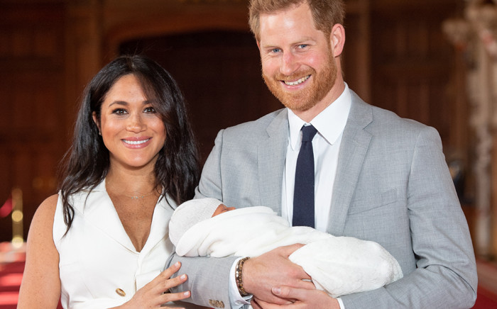 FILE: Britain's Prince Harry, Duke of Sussex (R), and his wife Meghan, Duchess of Sussex, pose for a photo with their newborn baby son in St George's Hall at Windsor Castle in Windsor, west of London on May 8, 2019.  Picture: AFP.