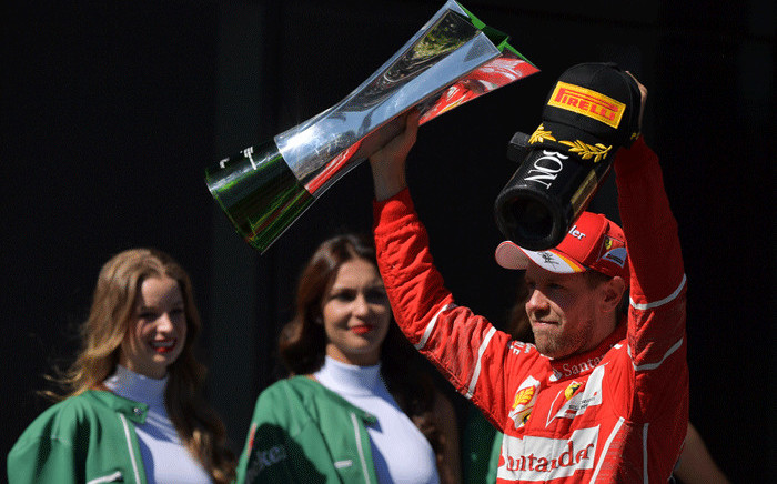  Ferrari's German driver Sebastian Vettel displays his trophy on the podium after winning the Brazilian Formula One Grand Prix, at the Interlagos circuit in Sao Paulo, Brazil, on 12 November 2017. Picture: AFP
