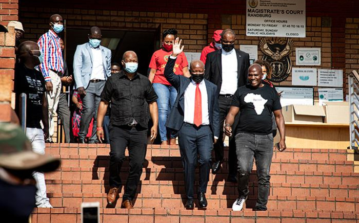 EFF leader Julius Malema (in red tie) at the Randburg Magistrates court on 28 October 2020 where he and EFF MP Mbuyiseni Ndlozi are on trial for allegedly assaulting a police officer in 2018. Picture: Xanderleigh Dookey/EWN.