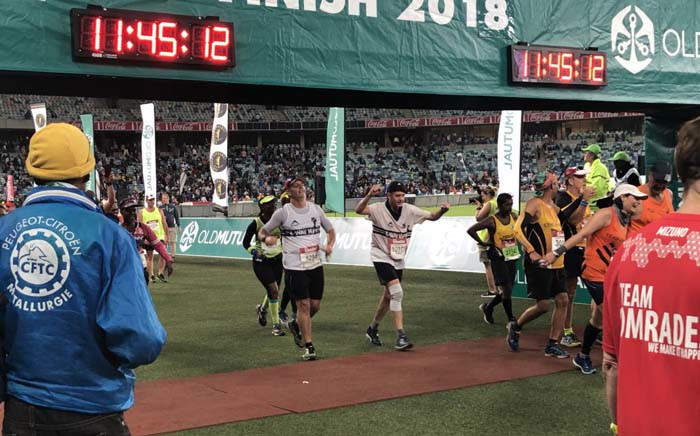 Runners cross the finish line 15 minutes before 2018 Comrades Marathon cut-off time. Picture: @ComradesRace/Twitter.