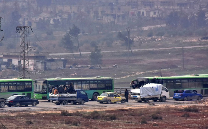 Buses are seen during an evacuation operation of Syrian rebel fighters and civilians from a opposition-held area of Aleppo towards rebel-held territory in the west of Aleppo’s province on 16 December, 2016. Picture: AFP.
