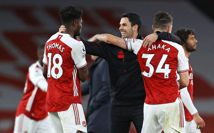 Arsenal coach Mikel Arteta and his team celebrate a 2-1 win against Tottenham on 14 March 2021. Picture: @arsenal/Twitter.