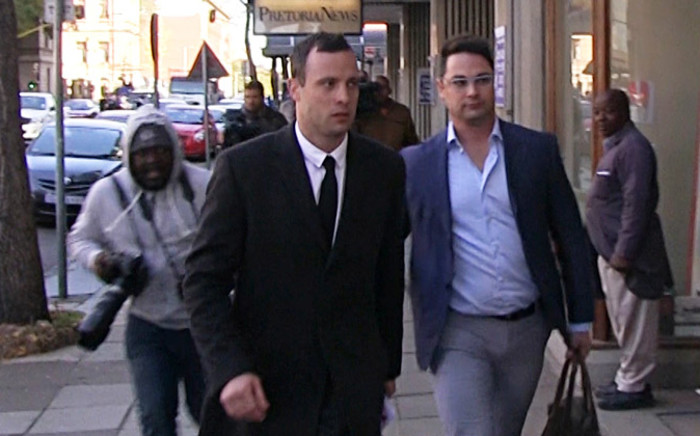 Oscar Pistorius leaves court with his brother Carl Pistorius after the athlete's defence team wrapped up its case on 8 July. Picture: Reinart Toerien/EWN.