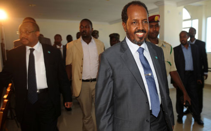 Newly elected Somali president Hasan Sheikh Mahmud arrives at the Jazeera hotel in Mogadishu on September 12, 2012 in Mogadsihu. Somalia's president survived an assassination bid, just two days into his new job, when bomb blasts claimed by Islamist rebels rocked the Mogadishu hotel where he was meeting Kenya's foreign minister. Al-Qaeda linked Shebab insurgents claimed responsibility for Wednesday's attack in which two blasts rocked the hotel where the new president was staying. Picture: AFP.