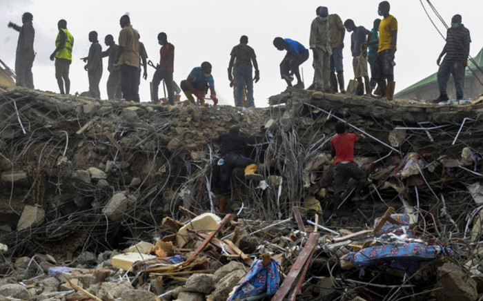 Nigerian rescue workers searching through rubble from the collapsed guesthouse at the Synagogue Church of All Nations in Lagos on 16 September 2014. Picture: EPA.