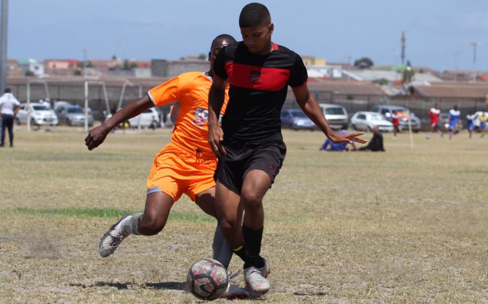 Ubuntu Football Academy's Uzayr Lee (foreground) controls the ball during a local football match. Picture: Supplied