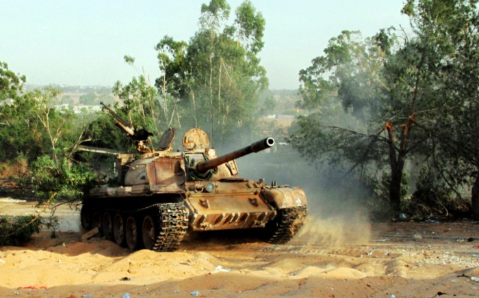 FILE: A picture taken on 17 August 2014 shows a tank during fightings between rival militias around Tripoli international airport. Picture: AFP.
