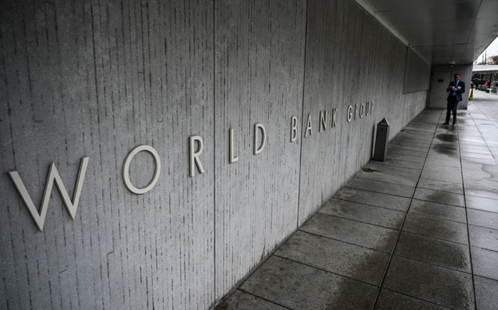 FILE: A person walks by the building of the Washington-based global development lender, The World Bank Group, in Washington on 17 January 2019. Picture: Eric BARADAT/AFP