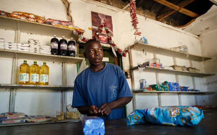 Solomon Chakauya, waits for customers in his grocery store, in Chinamhora district north-east of Zimbabwe's capital Harare on 10 December 2018.  Picture: AFP.