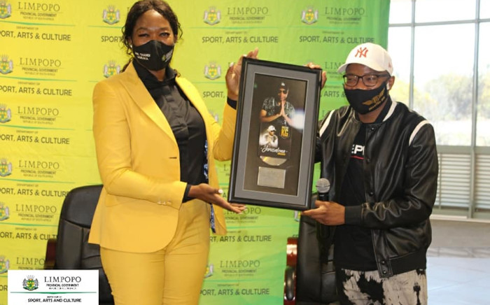Master KG (right) at the Limpopo Department of Arts & Culture, presenting MEC Thandi Moraka (left) with a plaque for his hit songs. Picture: Department of Sport, Arts and Culture Limpopo/Facebook