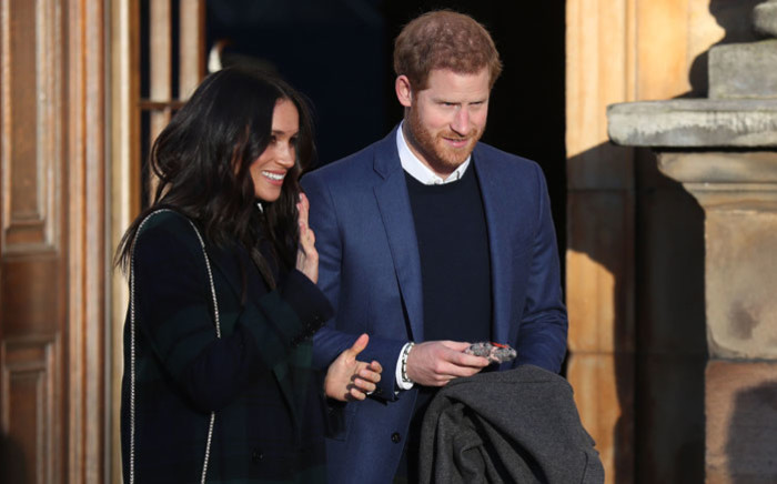 Britain's Prince Harry (R) and his fiancée US actress Meghan Markle leave a reception for young people in the Palace of Holyroodhouse in Edinburgh, during their visit to Scotland on 13 February, 2018. Picture: AFP