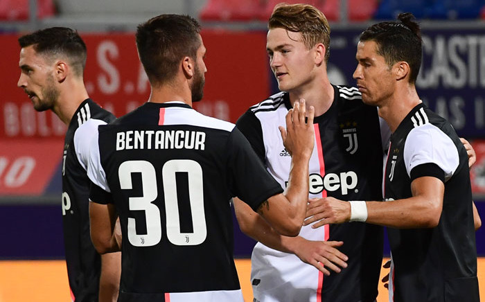 Juventus forward Cristiano Ronaldo (R) celebrates with defender Matthijs de Ligt (C) and midfielder Rodrigo Bentancur after scoring a penalty kick to open the scoring during the Italian Serie A football match Bologna vs Juventus on 22 June, 2020 at the Renato-Dall'Ara stadium in Bologna. Picture: AFP