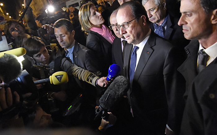 French President Francois Hollande (C), flanked by French Interior Minister Bernard Cazeneuve (Rear C), French Prime Minister Manuel Valls (R) and President of the French National Assembly Claude Bartolone (2nd R), addresses reporters near the Bataclan concert hall in central Paris, early on November 14, 2015. Picture: AFP