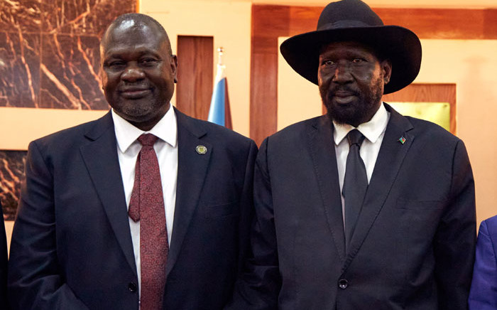 FILE: South Sudanese President Salva Kiir (R) stands with First Vice President Riek Machar as they attend a swearing-in ceremony at the State House in Juba, on 22 February 2020, South Sudan. Picture: ALEX MCBRIDE/AFP