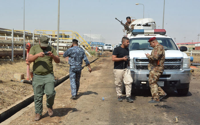 Iraqi security forces and members of the Saraya al-Salam (Peace Brigades), a group formed by Iraqi Shiite Muslim cleric Moqtada al-Sadr, inspect the site of suicide bombings at a power plant north of the capital Baghdad on 2 September 2017. Armed with grenades and wearing explosives belts, three attackers entered the facility in Samarra, about 100 kilometres north of the capital, at 2:00 am, an Iraqi security official told AFP, adding that the suicide bombers killed seven people and wounded 12 in the attack.