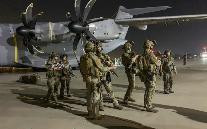 French soldiers stand guard near a military plane at airport in Kabul on August 17, 2021, as they arrive to evacuate French and Afghan nationals after the Taliban's stunning military takeover of Afghanistan. Picture: AFP