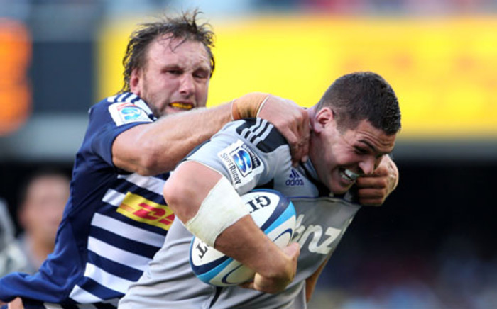 Andries Bekker (L) of the Stormers tackles Ben May of the Hurricanes during the Super 15 Rugby Match between the DHL Stormers and the Hurricanes at Newlands Stadium in Cape Town, on February 25, 2012.  Picture: AFP