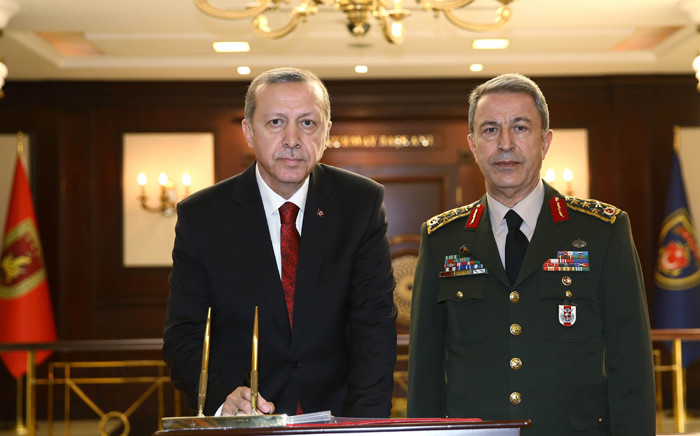 Turkish President Recep Tayyip Erdogan delivering a speech as Chief of the General Staff of the Turkish Armed Forces, as Hulusi Akar stands next to him during his condolence visit at the General Staff headquarters in Ankara. Turkish security forces on July 16, 2016 rescued the countryâs top army general in an operation in Ankara after a coup attempt, taking him to a safe location, the private CNN-Turk television reported. Picture: AFP.