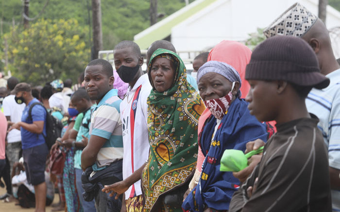 People wait for their relatives and friends to arrive in Pemba on 1 April 2021, from the boat of evacuees from the coasts of Palma. More than a thousand people evacuated from the shores of the town of Palma arrived at the sea port of Pemba after insurgents attacked Palma on 24 March 2021. Picture: Alfredo Zuniga/AFP